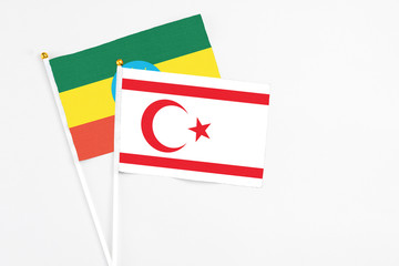 Northern Cyprus and Ethiopia stick flags on white background. High quality fabric, miniature national flag. Peaceful global concept.White floor for copy space.