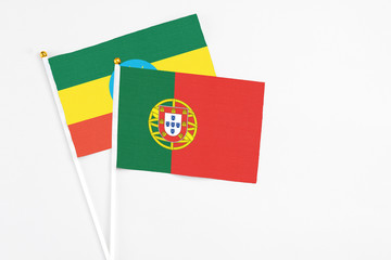 Portugal and Ethiopia stick flags on white background. High quality fabric, miniature national flag. Peaceful global concept.White floor for copy space.