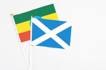 Scotland and Ethiopia stick flags on white background. High quality fabric, miniature national flag. Peaceful global concept.White floor for copy space.