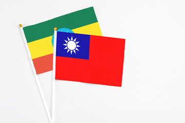 Taiwan and Ethiopia stick flags on white background. High quality fabric, miniature national flag. Peaceful global concept.White floor for copy space.