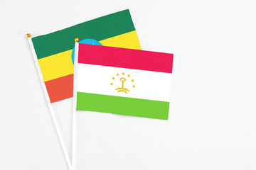 Tajikistan and Ethiopia stick flags on white background. High quality fabric, miniature national flag. Peaceful global concept.White floor for copy space.