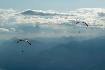Paragliders flying in mount Baldo, lake Garda, Italy