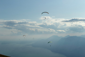 Paragliders flying in mount Baldo, lake Garda, Italy