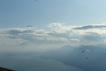 Paragliders flying in mount Baldo, lake Garda, Italy
