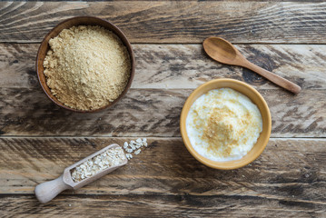 Bran oat in bowl in wooden background