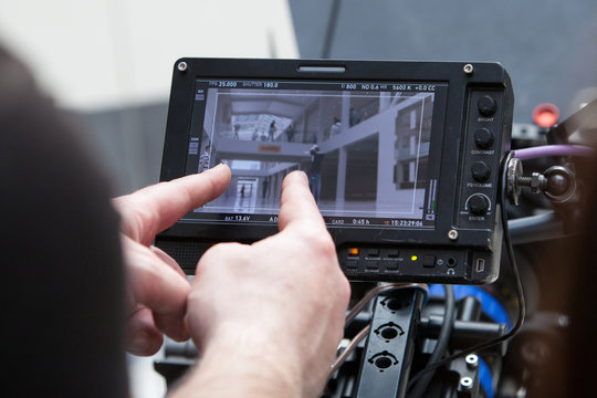 Video cameras on the set, backstage of the movie scene, operator hands