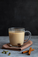 Indian tea masala chai with spices in a glass mug