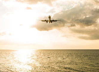 Landscape of sunset with Plane from Phuket at Nai Yang Beach Phuket Province, Thailand.