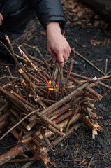 man lights a fire