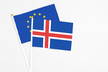 Obraz premium Iceland and European Union stick flags on white background. High quality fabric, miniature national flag. Peaceful global concept.White floor for copy space.