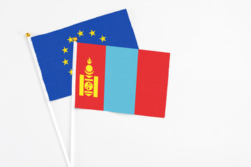 Mongolia and European Union stick flags on white background. High quality fabric, miniature national flag. Peaceful global concept.White floor for copy space.