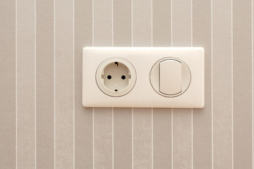 Electric soket and switch. Electric socket and switch on a wall