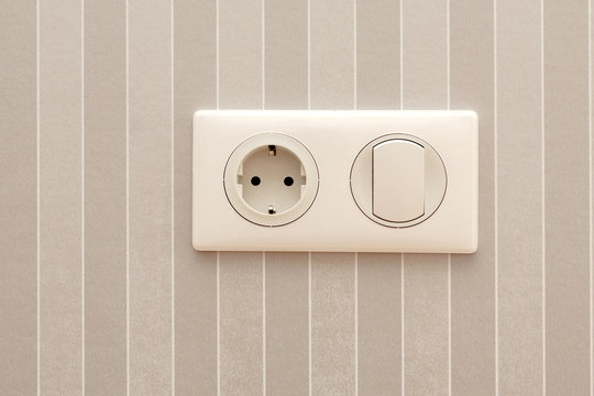 Electric soket and switch. Electric socket and switch on a wall
