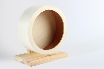Wooden wheel for the hamster close-up on a white background, side view