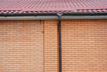 Roof gutter pipeline on brick house