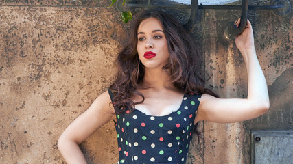 Elegant young woman posing on the street.