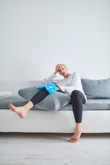 Injured woman holding ice pack / bag for cooling down the knee pain.