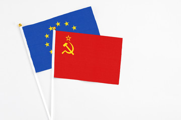 Soviet Union and European Union stick flags on white background. High quality fabric, miniature national flag. Peaceful global concept.White floor for copy space.