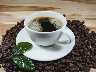 Coffee cup coffee beans coffee leaf on the table