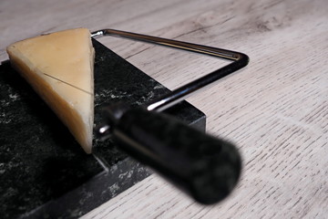 Close-up view to cheese cutter. Stone String Cheese Cutter