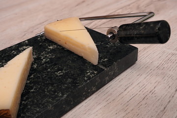 Close-up view to cheese cutter. Stone String Cheese Cutter