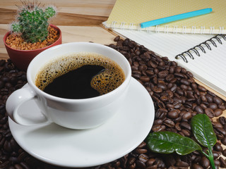 Coffee cup coffee beans coffee leaf on the table