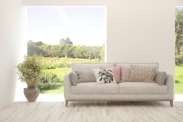 Stylish room in white color with sofa and summer landscape in window. Scandinavian interior design. 3D illustration