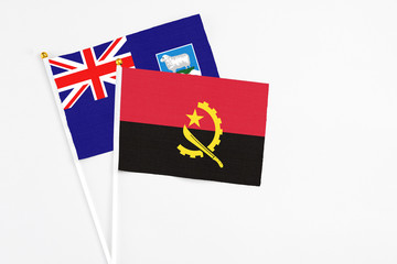Angola and Falkland Islands stick flags on white background. High quality fabric, miniature national flag. Peaceful global concept.White floor for copy space.