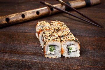 Sushi rolls on a wooden table