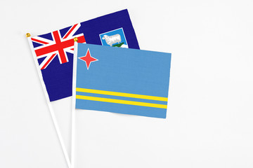 Aruba and Falkland Islands stick flags on white background. High quality fabric, miniature national flag. Peaceful global concept.White floor for copy space.