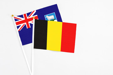 Belgium and Falkland Islands stick flags on white background. High quality fabric, miniature national flag. Peaceful global concept.White floor for copy space.