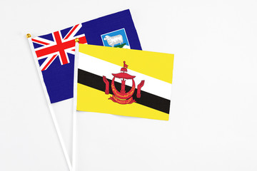 Brunei and Falkland Islands stick flags on white background. High quality fabric, miniature...