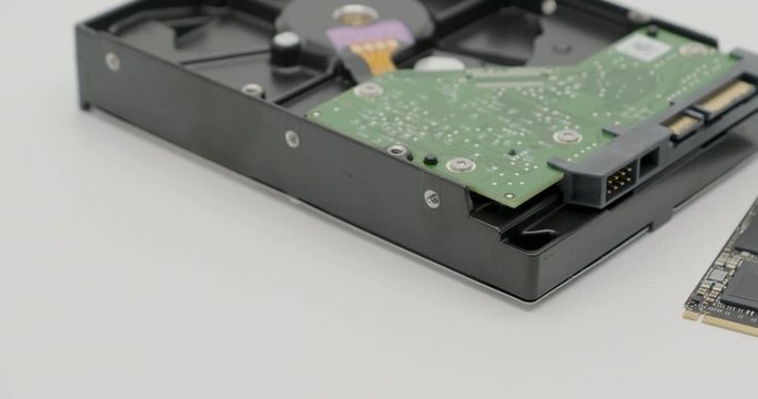 Truck shot of SSD M2 nvme pcie or solid state drive, the new next generation of storage drive with old HDD or hard disk drive antique isolated on white background