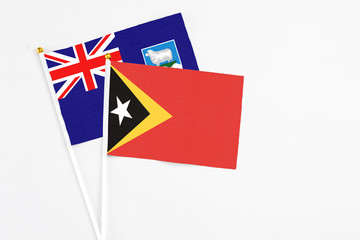 East Timor and Falkland Islands stick flags on white background. High quality fabric, miniature...