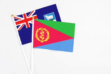 Eritrea and Falkland Islands stick flags on white background. High quality fabric, miniature national flag. Peaceful global concept.White floor for copy space.