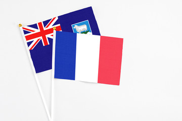 France and Falkland Islands stick flags on white background. High quality fabric, miniature national flag. Peaceful global concept.White floor for copy space.