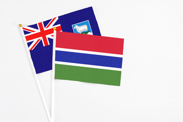 Gambia and Falkland Islands stick flags on white background. High quality fabric, miniature national flag. Peaceful global concept.White floor for copy space.