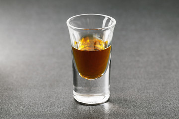 Shot with whiskey on a dark background, close-up