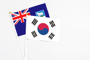 South Korea and Falkland Islands stick flags on white background. High quality fabric, miniature national flag. Peaceful global concept.White floor for copy space.