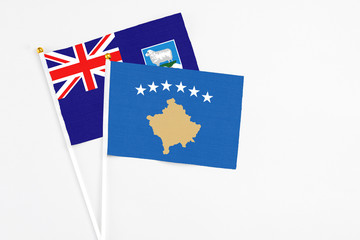 Fototapeta premium Kosovo and Falkland Islands stick flags on white background. High quality fabric, miniature national flag. Peaceful global concept.White floor for copy space.