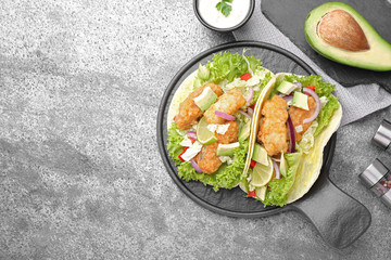 Delicious fish tacos served on grey table, flat lay with space for text