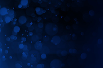 Christmas blue bokeh on a black background, Abstract.