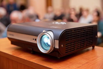 LCD video projector at business conference or lecture in office with copy space. projector on...