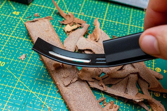 Thinning brown leather stripe with skiver tool. Leather craft hobby