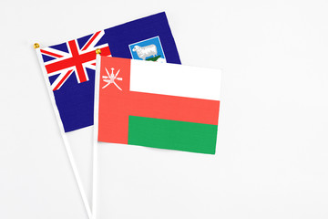 Oman and Falkland Islands stick flags on white background. High quality fabric, miniature national...