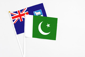 Pakistan and Falkland Islands stick flags on white background. High quality fabric, miniature...