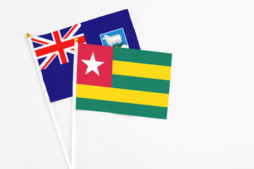 Togo and Falkland Islands stick flags on white background. High quality fabric, miniature national...