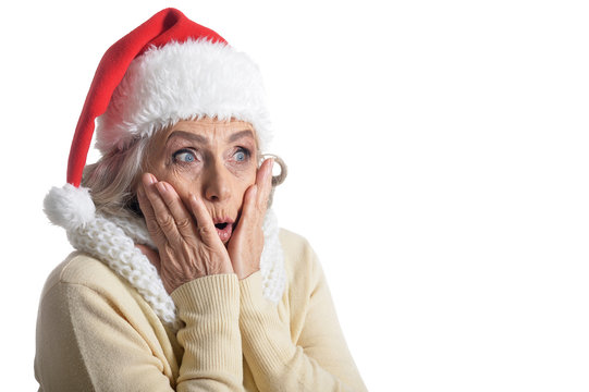 Portrait of surprised senior woman in Santa hat