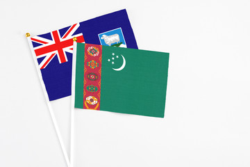 Turkmenistan and Falkland Islands stick flags on white background. High quality fabric, miniature national flag. Peaceful global concept.White floor for copy space.