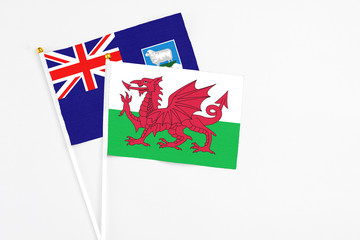 Wales and Falkland Islands stick flags on white background. High quality fabric, miniature national flag. Peaceful global concept.White floor for copy space.